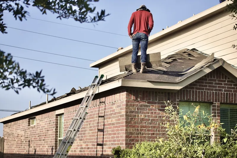 Professional roofer working on a residential roof in Balboa